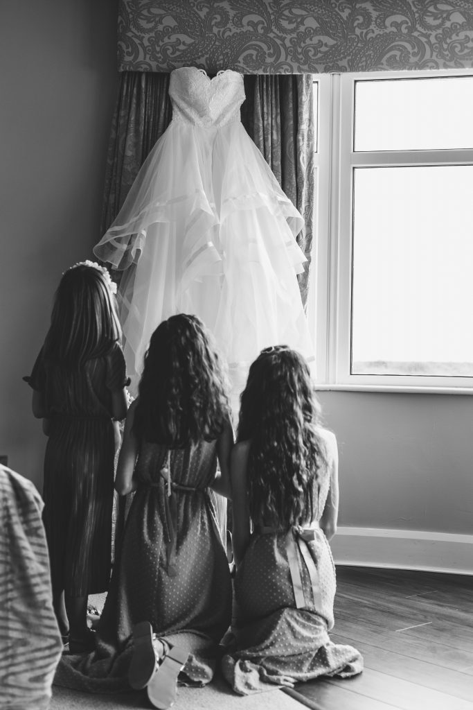 Jodi and Jade wedding photography Dublin Wexford girls staring at wedding dress