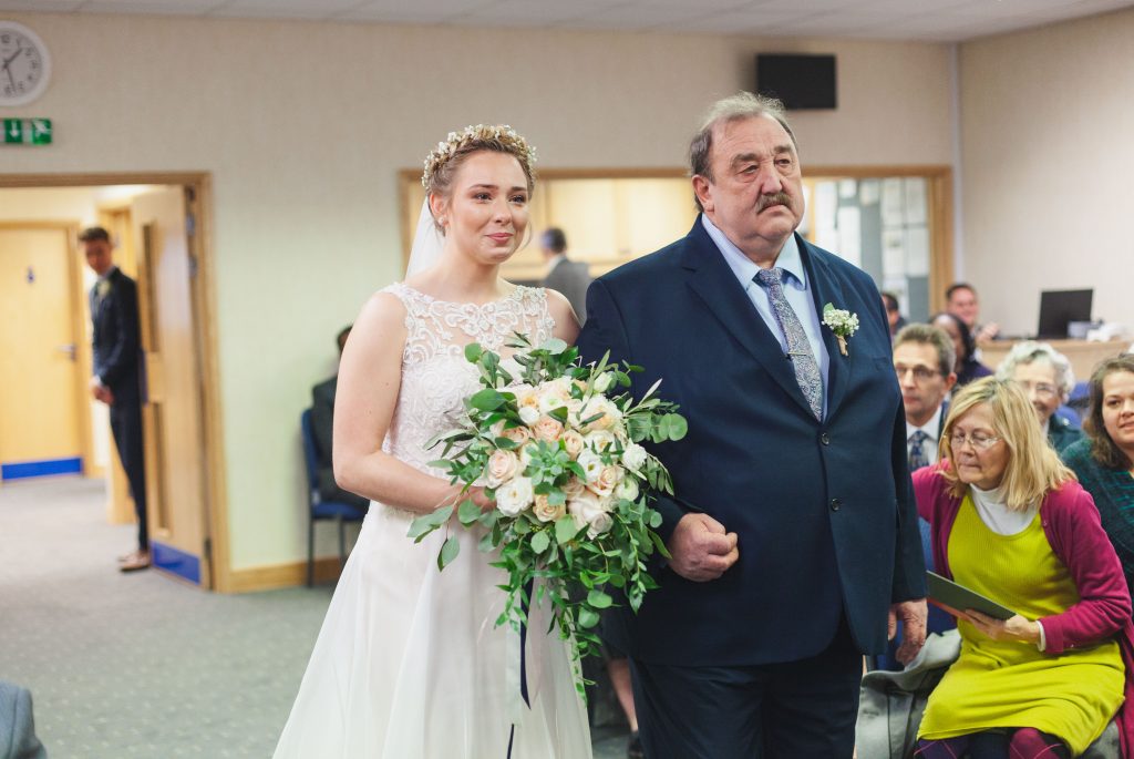 bride and father walk down the isle