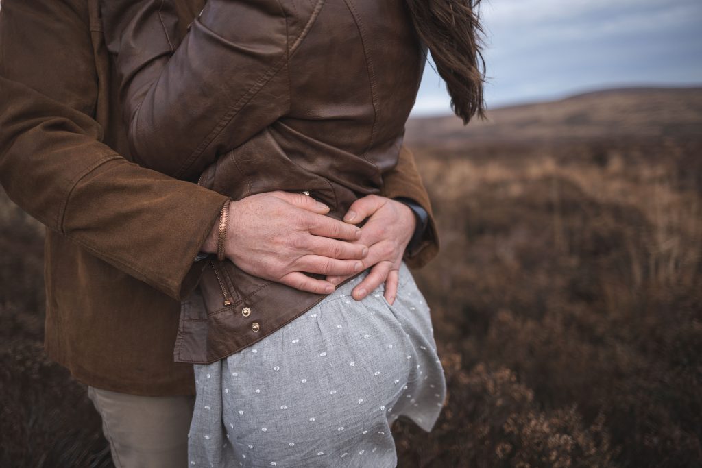 Marli + Andre wicklow mountains engagement shoot couple his hands on her waist