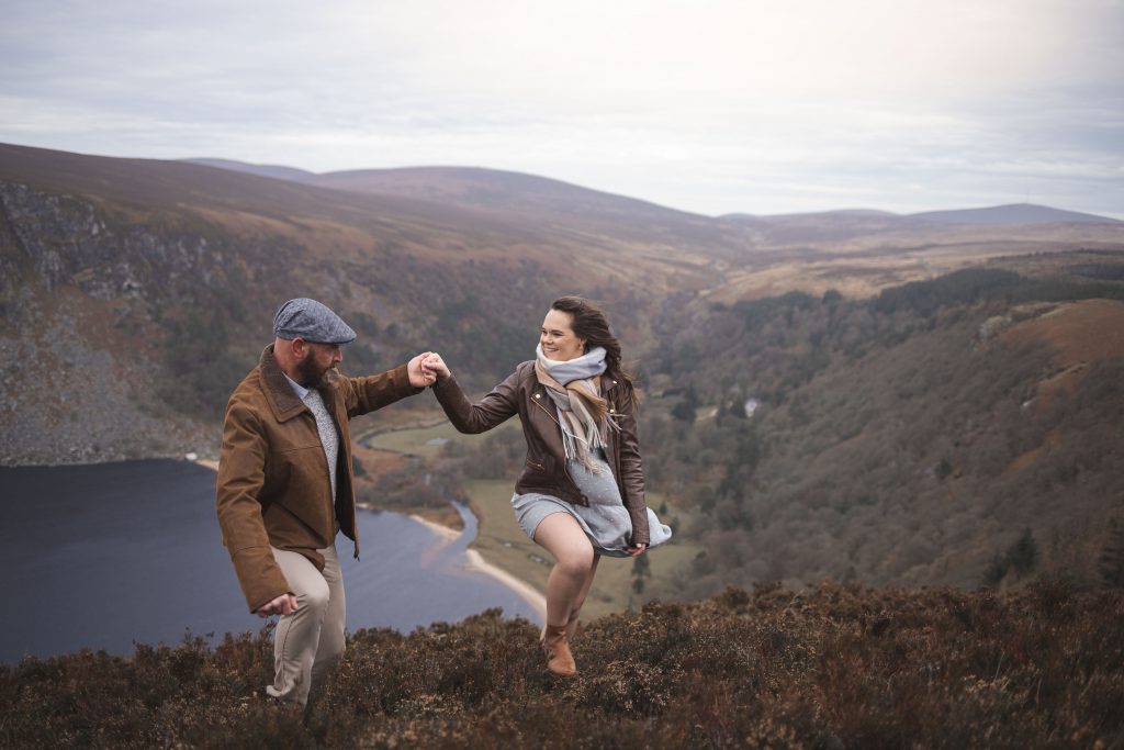 Marli + Andre wicklow mountains engagement shoot happy couple walking up a hill in the mountains