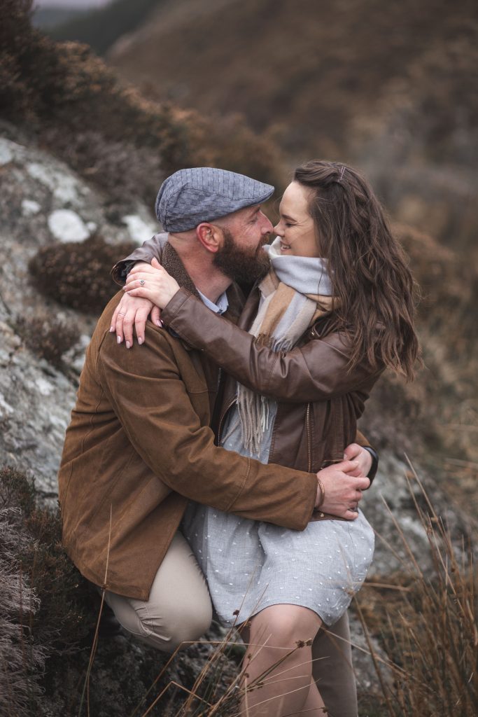 Marli + Andre wicklow mountains engagement shoot kissing on a rock