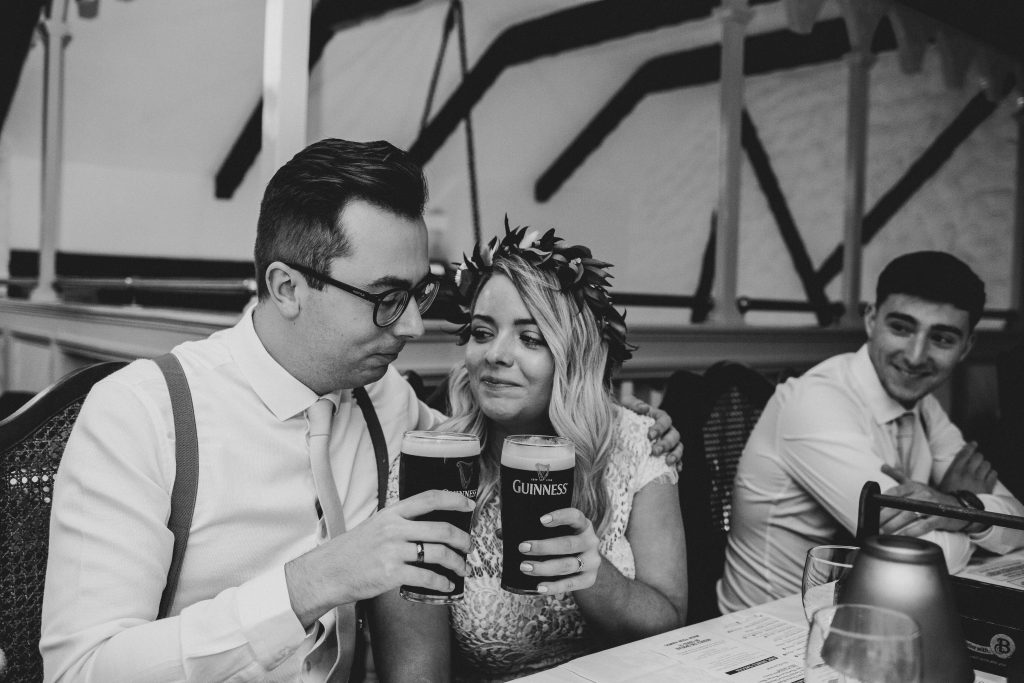 Jack and Katie the Ramble Inn Bar Restaurant Elopement wedding photography couple sharing a pint of guinness