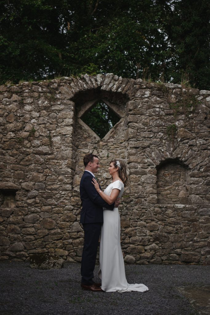 Gemma and Paddy New Ross wedding couple castle ruins with couple facing each other