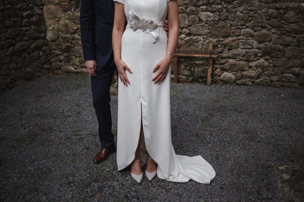 Gemma and Paddy New Ross wedding couple castle ruins below the hips shot