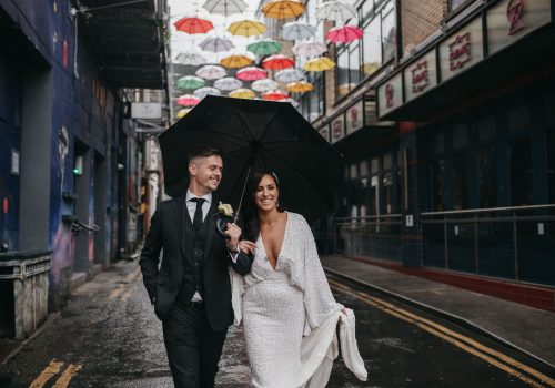 Troy and Laura Dublin City intimate Wedding under the Dublin umbrellas walking together