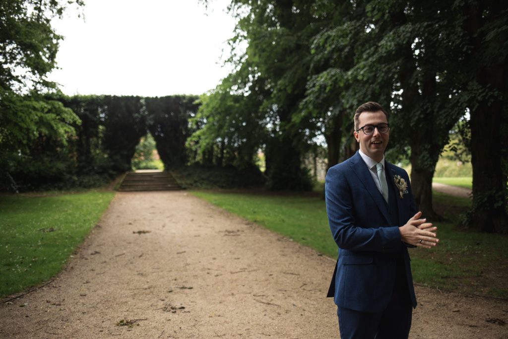 Jack and Katie Antrim Castle gardens elopement groom waiting for the first look