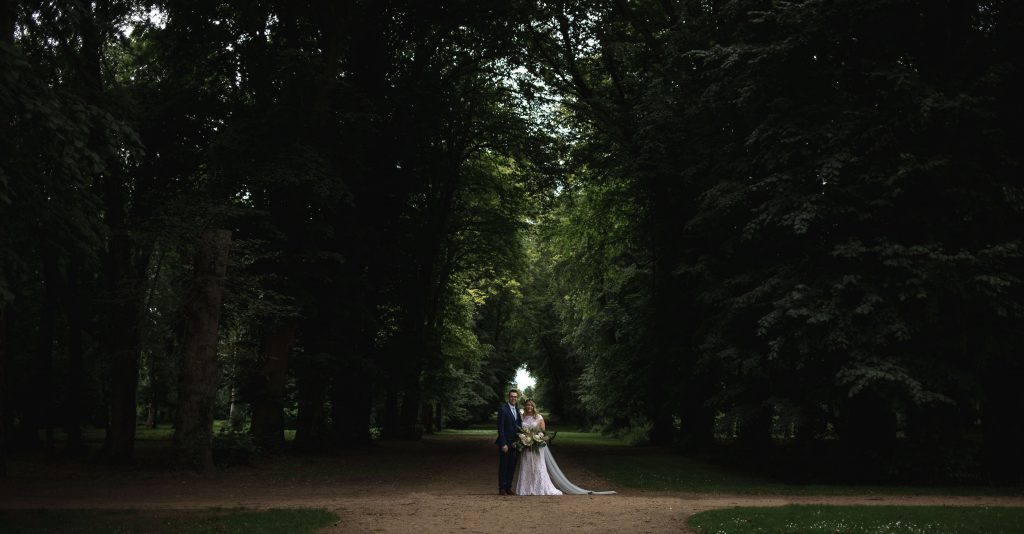Jack and Katie Antrim Castle gardens elopement posing under the trees