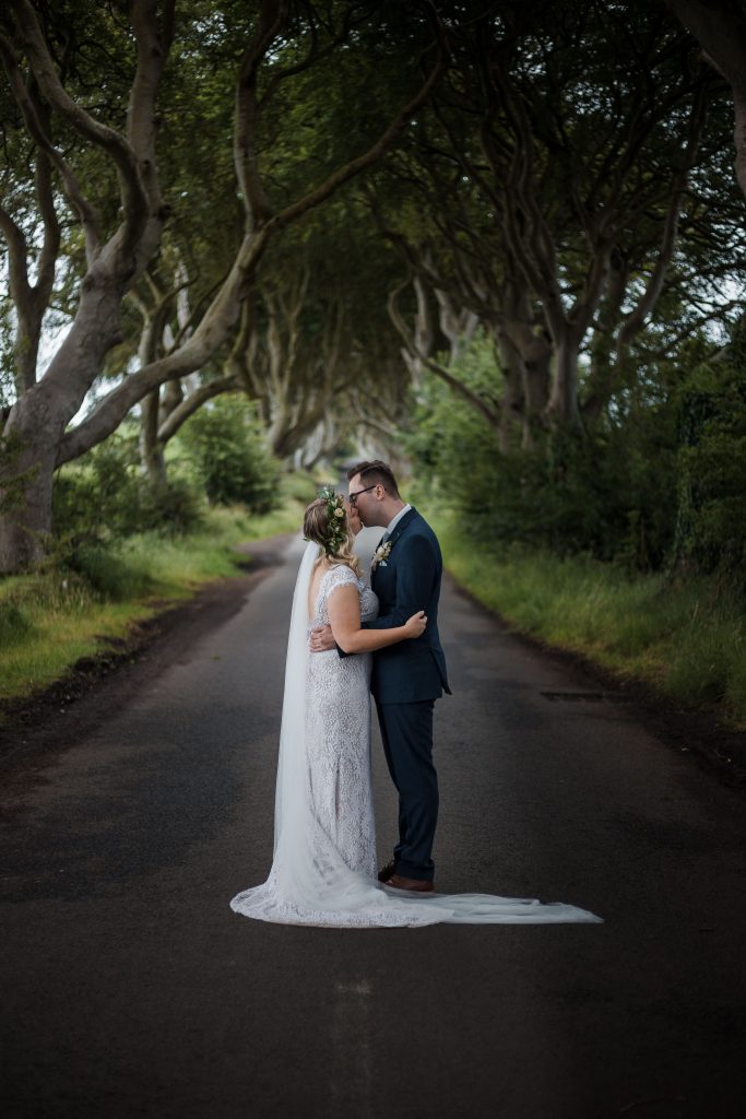 Jack and Katie Dark hedges Elopement wedding photography kissing in the middle of the road