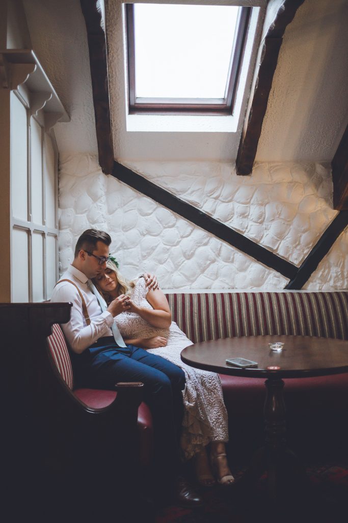 Jack and Katie the Ramble Inn Bar Restaurant Elopement wedding photography couple cuddling together in the pub