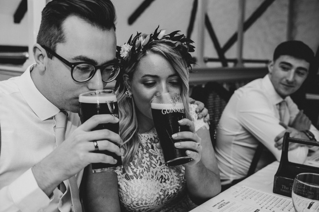 Jack and Katie the Ramble Inn Bar Restaurant Elopement wedding photography couple sharing a pint of guinness