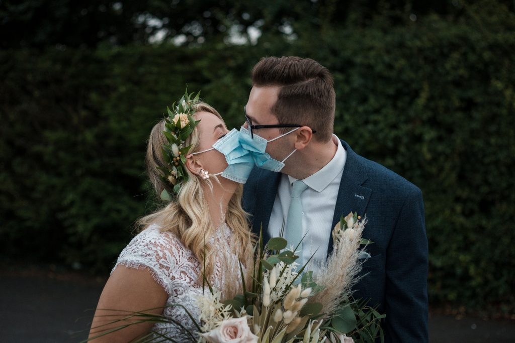 Jack and Katie Antrim Covid Elopement wedding photography couple kissing with face masks